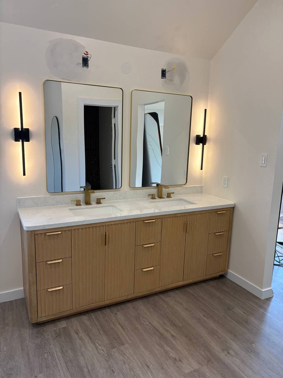 Double vanity with marble countertop and custom tile work